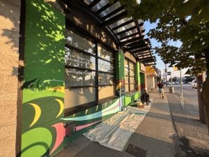 The mural taking shape along the South Vancouver Neighbourhood House building